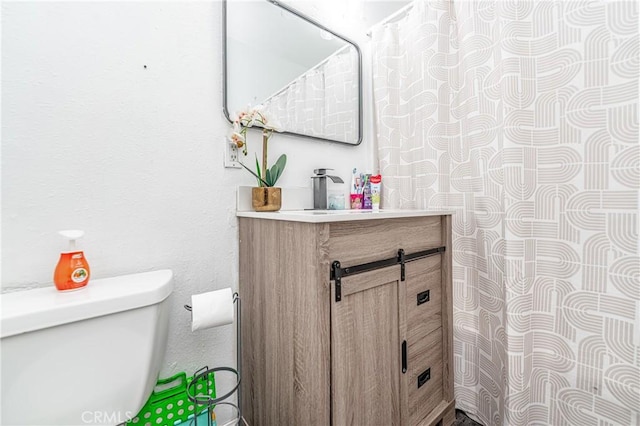 bathroom featuring vanity and toilet