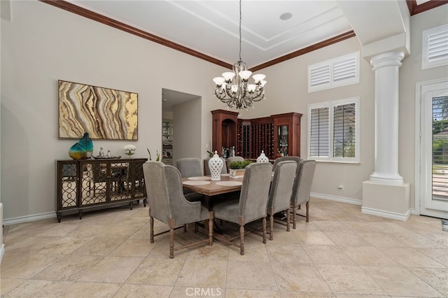 dining area featuring ornate columns, a high ceiling, crown molding, and a notable chandelier