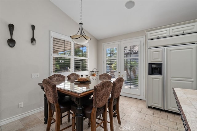 dining room featuring french doors and vaulted ceiling