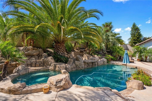 view of pool with an in ground hot tub