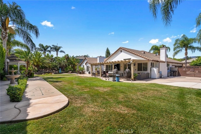 back of property featuring a patio and a lawn