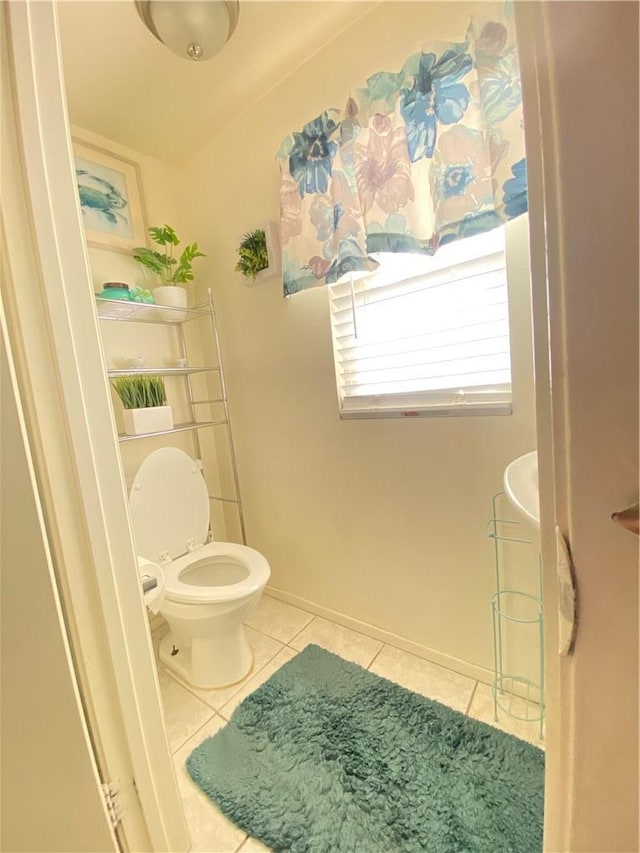 bathroom with toilet and tile patterned flooring