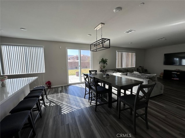 dining area featuring dark wood-type flooring