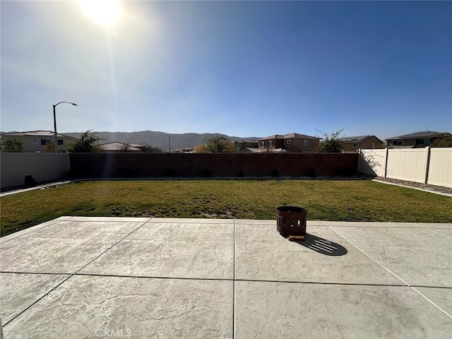 view of yard with a mountain view and a patio area