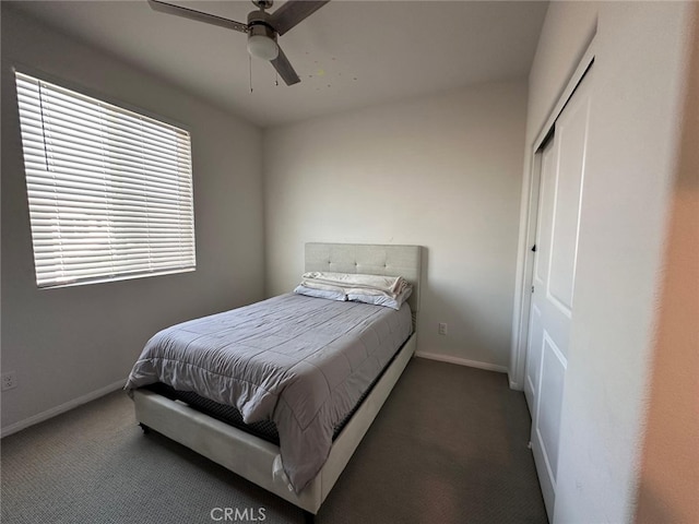 carpeted bedroom featuring ceiling fan and a closet