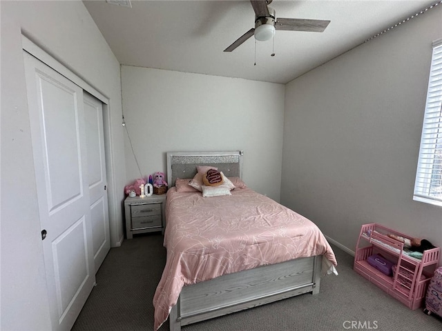 carpeted bedroom with ceiling fan and a closet