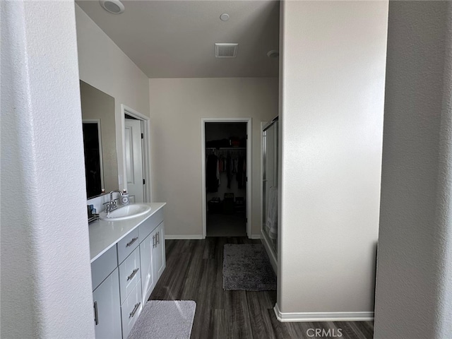 bathroom with vanity and hardwood / wood-style floors