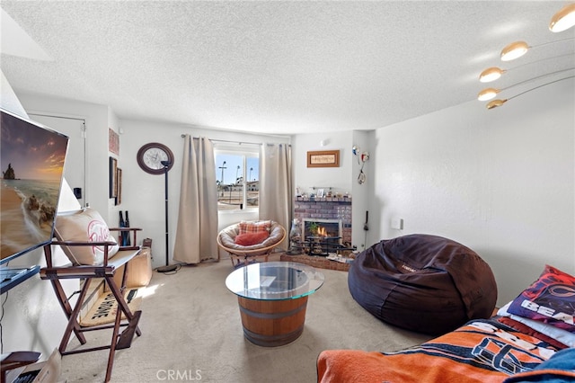 carpeted living room with a brick fireplace and a textured ceiling