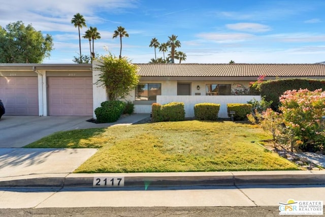 single story home with a front lawn and a garage