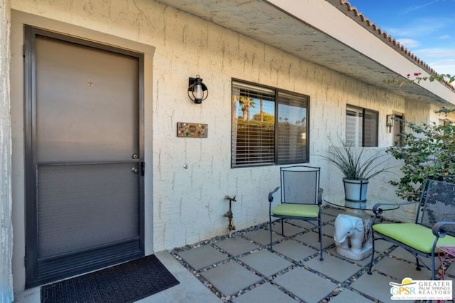 doorway to property with a patio area