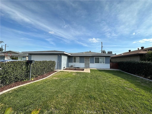 rear view of property with a yard and a garage