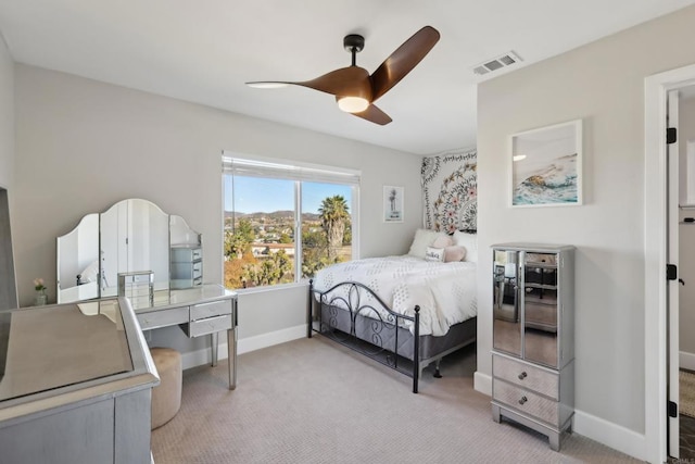 bedroom featuring light carpet and ceiling fan