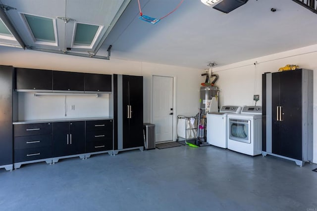 garage with a garage door opener, separate washer and dryer, and gas water heater