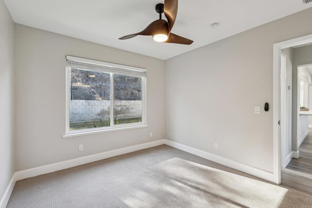 unfurnished room featuring ceiling fan and light carpet