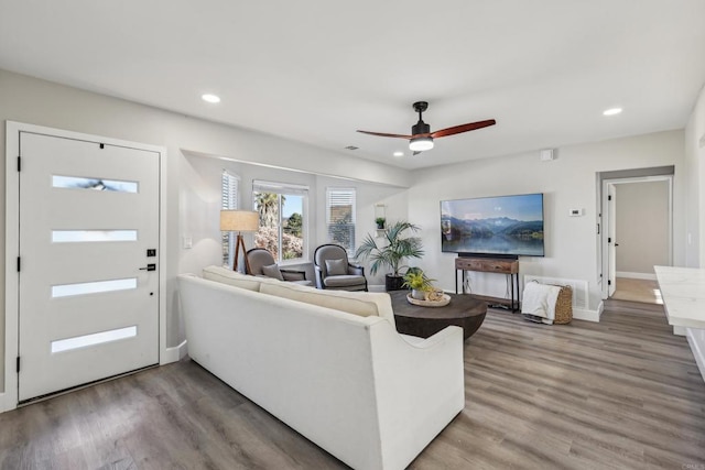 living room featuring hardwood / wood-style floors and ceiling fan