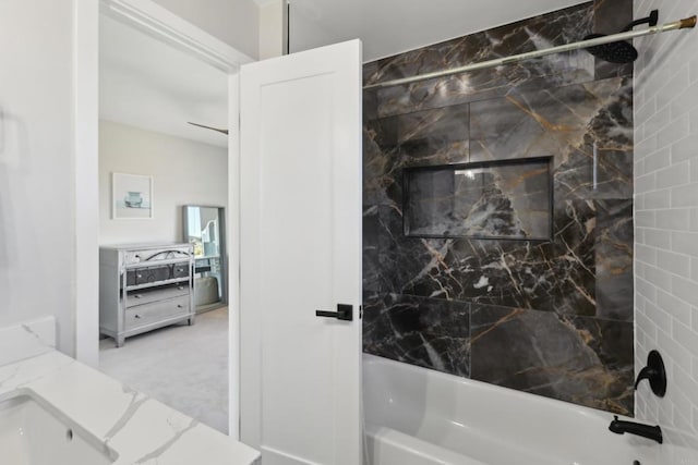 bathroom with vanity and tiled shower / bath