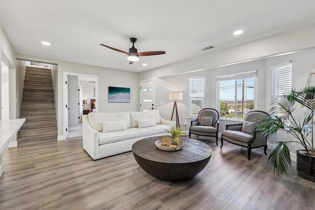 living room featuring ceiling fan and light hardwood / wood-style flooring