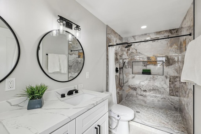 bathroom featuring toilet, curtained shower, and vanity