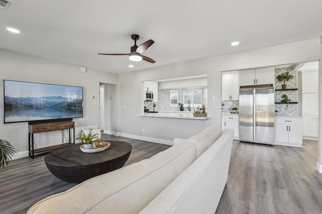 living room with ceiling fan and hardwood / wood-style flooring