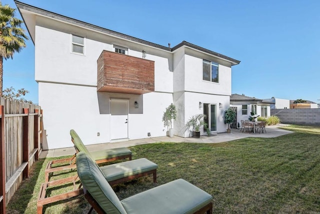 back of property featuring a yard and a patio