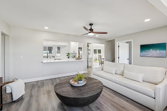 living room with ceiling fan, hardwood / wood-style floors, and a wealth of natural light