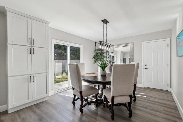 dining space featuring an inviting chandelier and hardwood / wood-style flooring