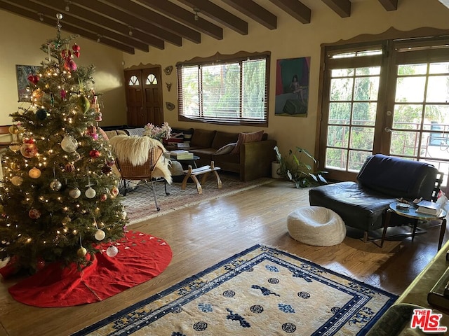 living area with beam ceiling and wood-type flooring