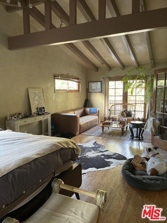 bedroom featuring hardwood / wood-style floors and lofted ceiling with beams