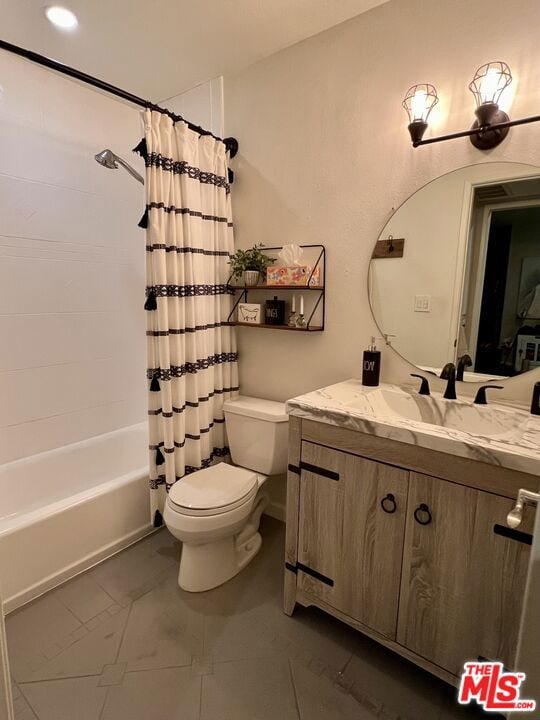 full bathroom with vanity, shower / bath combo with shower curtain, and toilet