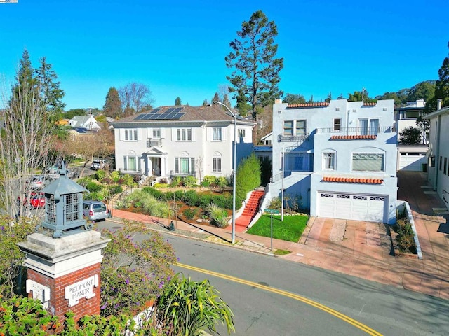 view of front of home with solar panels and a garage