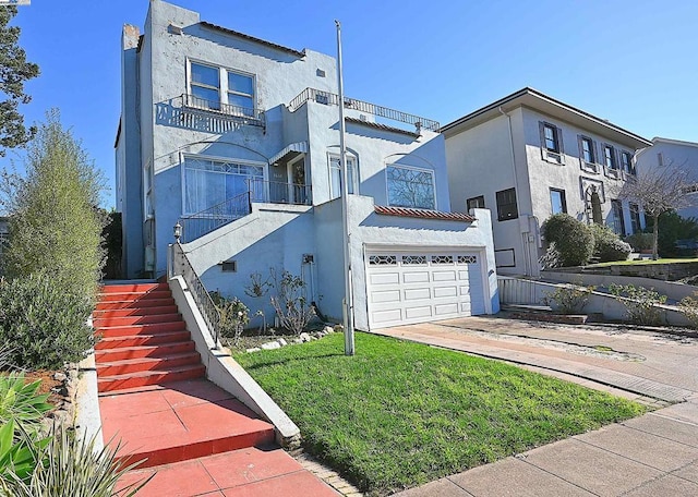 view of front facade with a balcony, a garage, and a front lawn