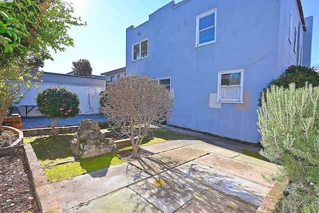 view of side of home featuring a patio area