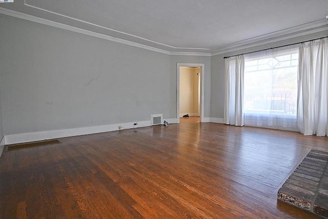 empty room featuring ornamental molding and wood-type flooring