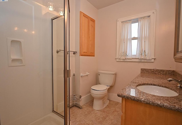 bathroom with toilet, tile patterned flooring, an enclosed shower, and vanity