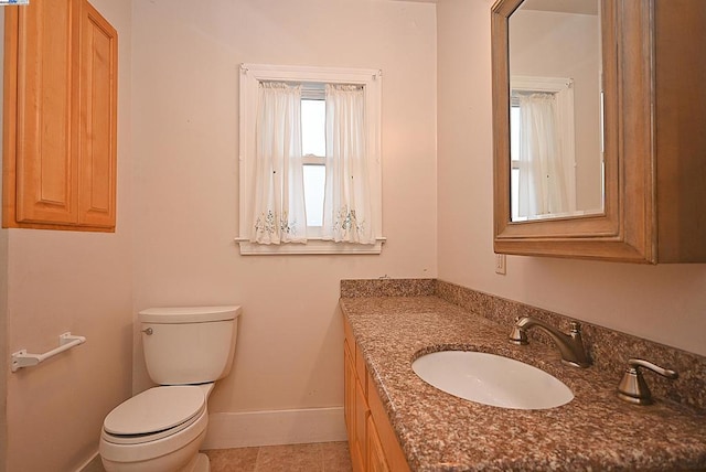 bathroom featuring toilet, vanity, and tile patterned floors