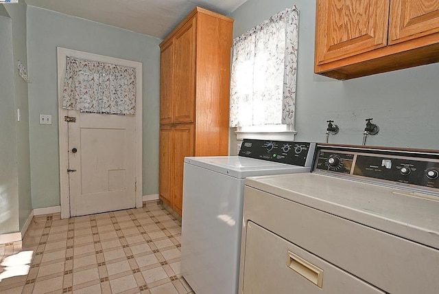 washroom featuring washer and dryer and cabinets