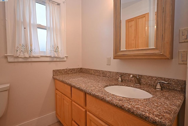 bathroom featuring toilet and vanity