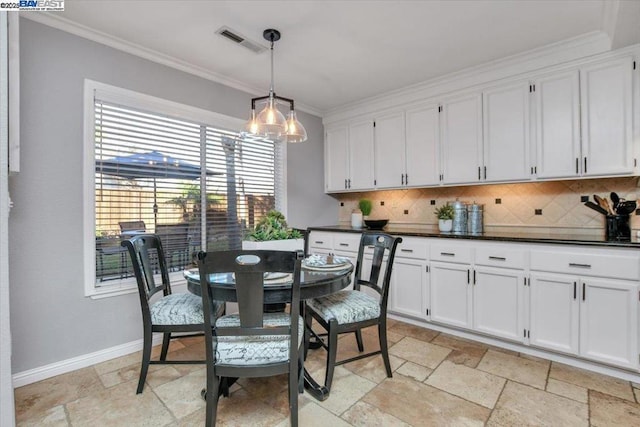 dining area featuring crown molding