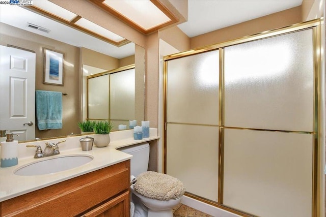 bathroom with vanity, toilet, and walk in shower