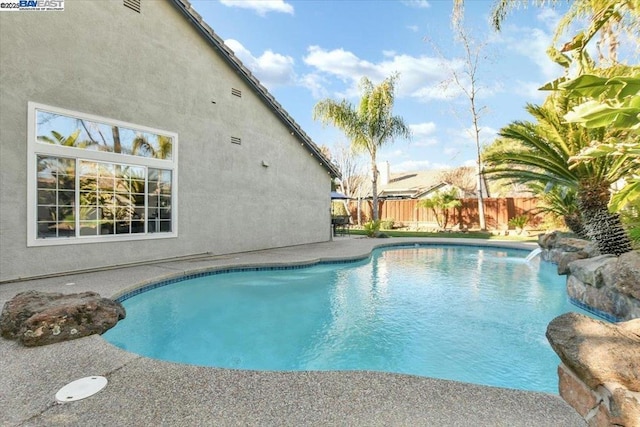 view of swimming pool with pool water feature