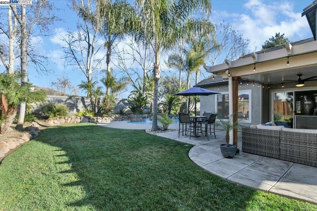 view of yard featuring ceiling fan and a patio area