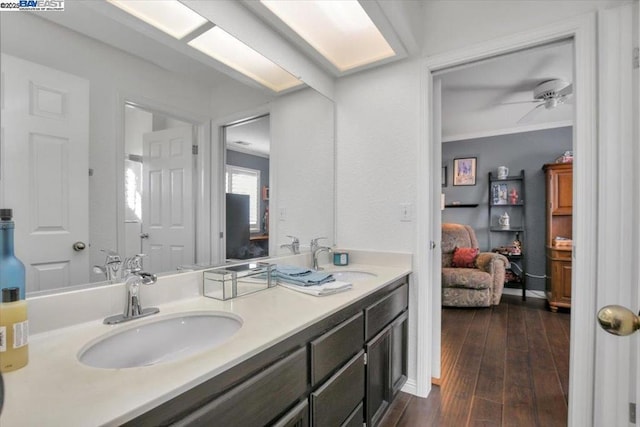 bathroom with vanity, hardwood / wood-style floors, and ceiling fan