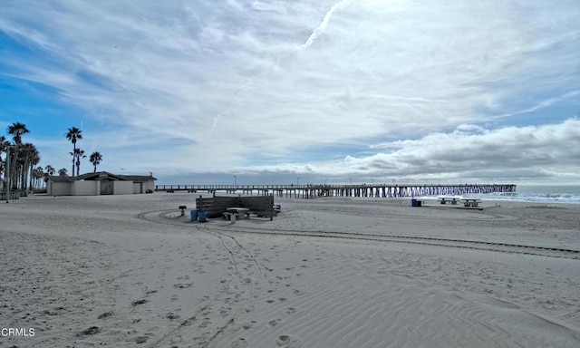 view of home's community featuring a water view and a view of the beach