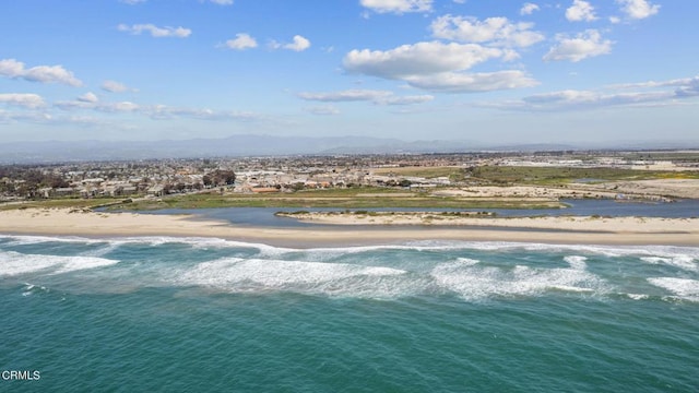 birds eye view of property with a beach view and a water view