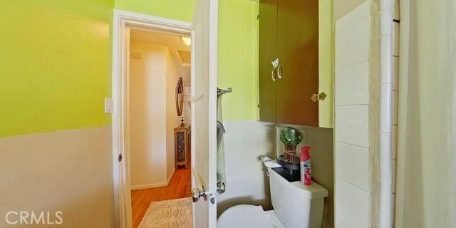 bathroom with toilet and wood finished floors