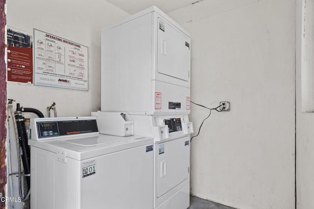 washroom featuring stacked washer and clothes dryer