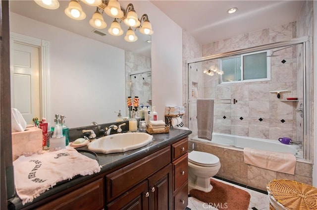 full bathroom featuring combined bath / shower with glass door, tile patterned flooring, vanity, and toilet