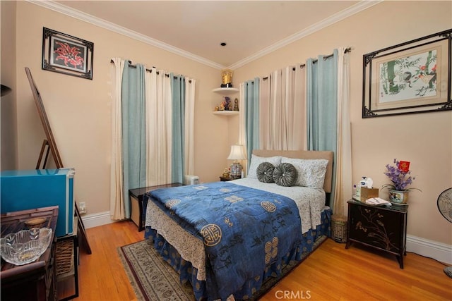 bedroom with hardwood / wood-style flooring and ornamental molding