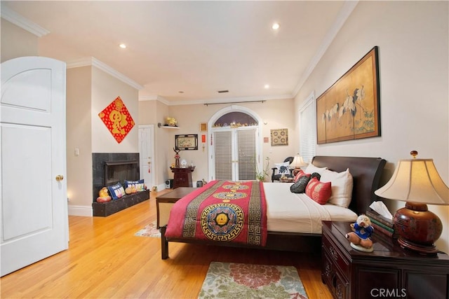 bedroom featuring light wood-type flooring and ornamental molding