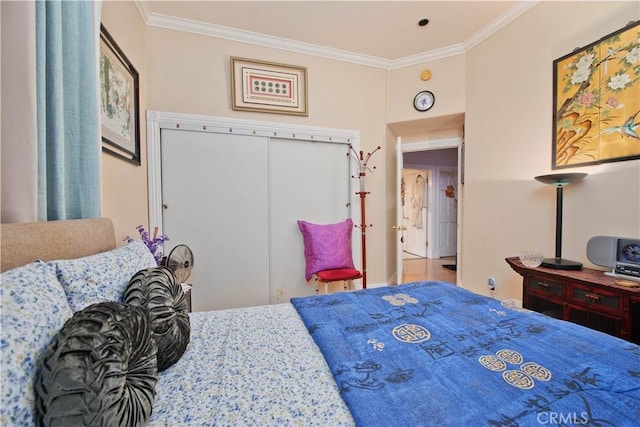 bedroom with ornamental molding and a closet